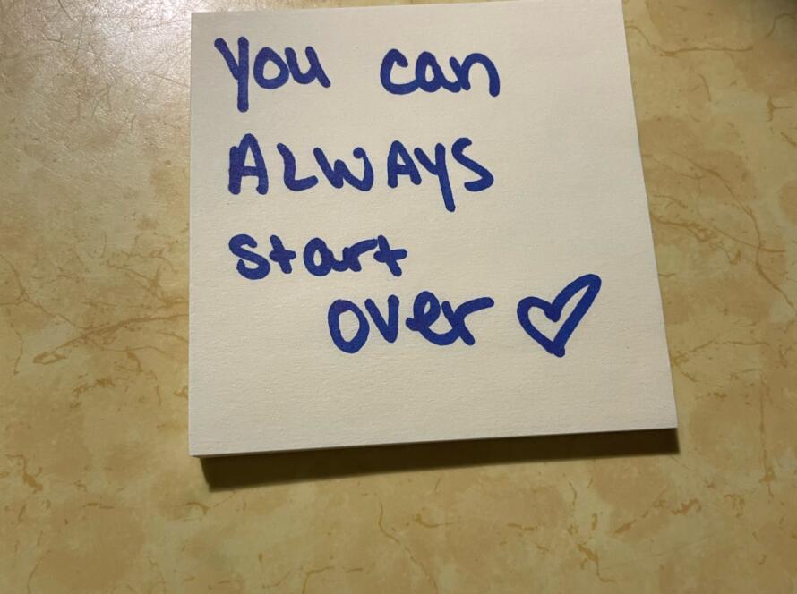 Photo of a sticky note with "You can always start over" and a drawn heart on it